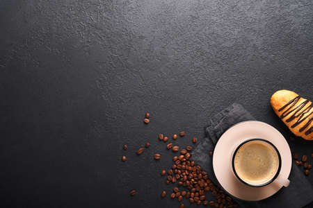 Coffee and croissants. Espresso coffee and croissant with chocolate on old on black concrete table. Perfect Croissant Breakfast in the morning. rustic style. top view. Mock up.の写真素材