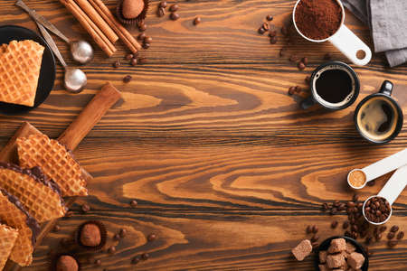 Coffee and dutch waffles. Espresso coffee and dutch waffles or syrupwaffles cookies with chocolate on old wooden table. Perfect syrupwaffles cookies for Breakfast. top view. Mock up.の写真素材