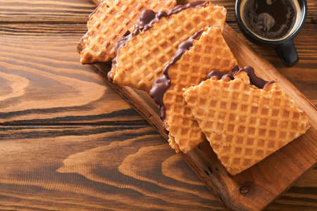 Coffee and dutch waffles. Espresso coffee and dutch waffles or syrupwaffles cookies with chocolate...
