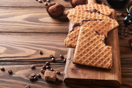 Coffee and dutch waffles. Espresso coffee and dutch waffles or syrupwaffles cookies with chocolate on old wooden table. Perfect syrupwaffles cookies for Breakfast. top view. Mock up.の写真素材