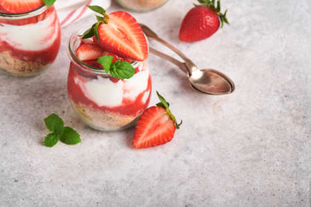 Strawberry Cheesecake. Cheesecake or trifle with strawberry in glass on old gray concrete background table background. Cheesecake without baking. Dessert. new york. copyspace. food background.の写真素材