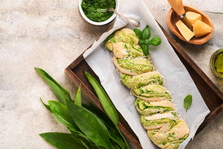 Braided wild garlic pesto brioche. Homemade raw or uncooked fresh pull apart bread with wild garlic...