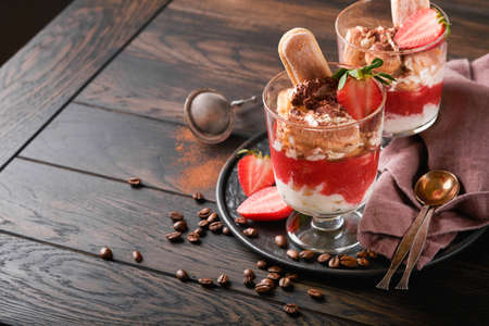 Strawberry tiramisu. Traditional Italian dessert tiramisu in glass with fresh strawberry and mint...
