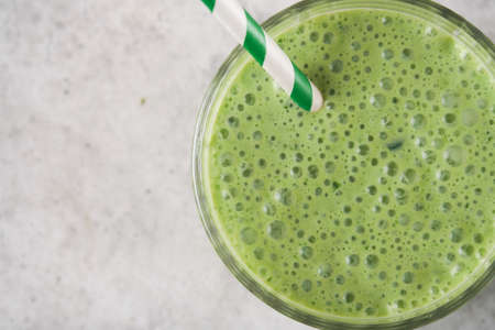 Spinach smoothie healthy green. Vegan smoothie or milkshake from spinach, banana and chia seeds on...