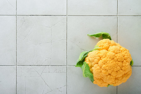 Colorfu cauliflower. Various sort of cauliflower on stone tiles gray concrete background. Purple, yellow, white and green color cabbages. Broccoli and Romanesco. agricultural harvest. Mock up.の写真素材