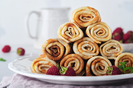 Pancakes. Stack of crepes or thin pancakes with berries, with raspberries and honey for breakfast....