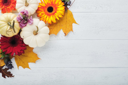 Halloween autumn festive background. Autumn decor from pumpkins, berries, maple leaves and chestnuts...