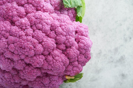 Purple cauliflower on gray concrete background. Broccoli and Romanesco.の写真素材