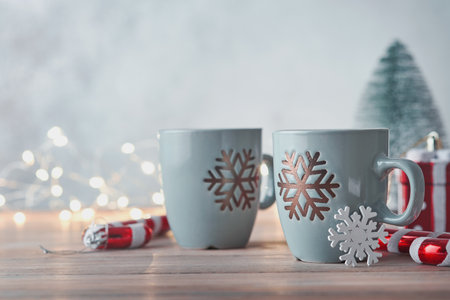 Mary Christmas. Two cups of hot cocoa with marshmallows. Christmas homemade cup of hot chocolate with marshmallow on wooden table backgrounds with lights bokeh. Christmas food drink concept.の写真素材