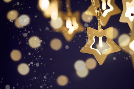 Christmas backgrounds. Small decorative Christmas stars light with bokeh lights background....