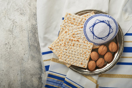 Passover celebration concept. Matzah, red kosher and walnut. Traditional ritual Jewish bread matzah,...