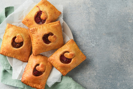 Valentines day heart shaped Hand pies. Mini puff pastry or hand pies stuffed with apple and sprinkle...