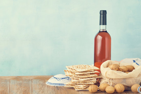 Passover celebration concept. Matzah, red kosher and walnut. Traditional ritual Jewish bread matzah,...