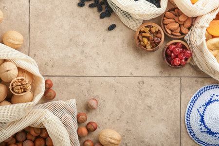 Tu Bishvat celebration concept. Mix of dry fruits and nuts almonds, hazelnuts, walnuts, apricots, prunes, cherries, raisins, dates, apples, figs over wooden table. Jewish holiday, new year of trees.の写真素材