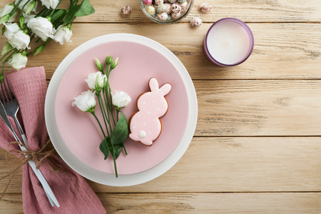 Easter brunch table setting. Spring Easter holiday concept with white, pink plate and napkin with...