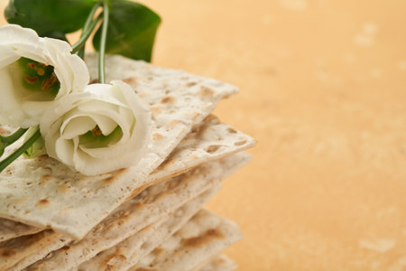 Matzah Passover celebration concept. Traditional ritual Jewish bread on sand color old wall background. Passover food. Pesach Jewish holiday of Passover celebration concept. Passover food.の写真素材