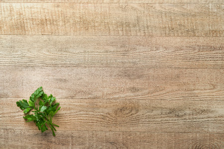 food cooking background. Green parsley branches at light old wooden table background. food ingredients topの写真素材