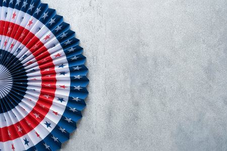 4th of July background. USA paper fans, Red, blue, white stars and confetti on gray old concrete...