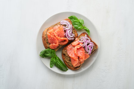 Sandwiches with salted salmon, avocado guacamole, red onions and basil. Smorrebrod. Set of Danish open sandwiches. Healthy food, breakfast. Clean eating, dieting, vegan food concept. top view.の写真素材
