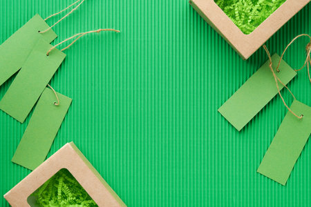 Green Friday background mock up. Sale Tag on green background. Paper shopping boxes and green tag. Environmentally friendly shopping idea, useful things on sale. Reducing excessive consumption.の写真素材