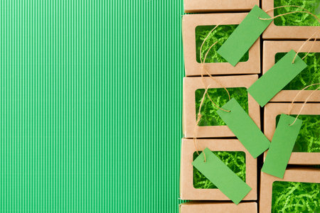 Green Friday background mock up. Sale Tag on green background. Paper shopping boxes and green tag. Environmentally friendly shopping idea, useful things on sale. Reducing excessive consumption.の写真素材