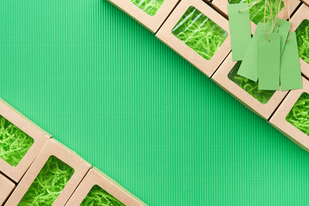 Green Friday background mock up. Sale Tag on green background. Paper shopping boxes and green tag. Environmentally friendly shopping idea, useful things on sale. Reducing excessive consumption.の写真素材