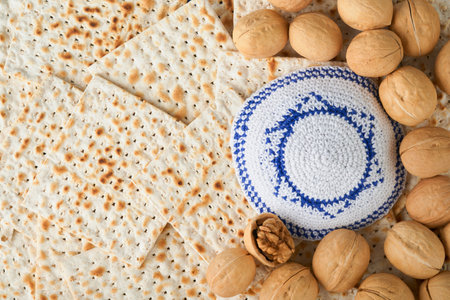 Passover celebration concept. White kippah with Star of David on Matzah texture background. Passover food. Pesach Jewish holiday. Traditional ritual Jewish bread. Passover food. top view. Mock up.の写真素材