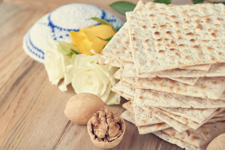 Passover celebration concept. Matzah, red kosher and walnut. Traditional ritual Jewish bread matzah,...