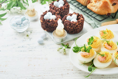 Stuffed or deviled eggs yolk, shrimp, pea microgreens with paprika for easter table decorate fresh...
