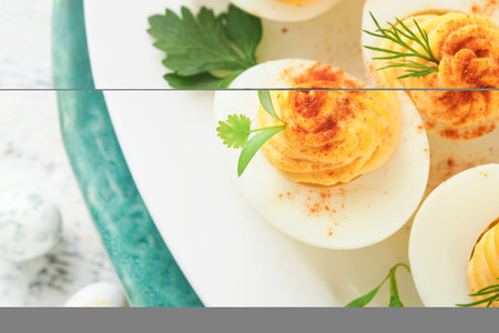 Easter stuffed eggs. Traditional Easter brunch or dinner with stuffed eggs with paprika, carrot cake...
