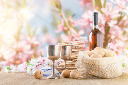 Passover celebration concept. Matzah, red kosher and walnut on wooden vintage table in front of...