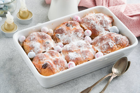 Easter Hot cross buns. Traditional Easter treats cross buns with raisins, butter, chocolate candy...