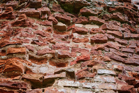 Old brick red wall,brickwork from an old brick in rustic style. Structure and pattern of destroyed stone grunge wall. Retro style background. Copy space.の写真素材
