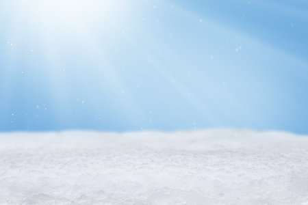 Christmas background with snowdrift, falling snow and sun rays with copy space. Empty winter background. Banner, website header, poster with cope space.の写真素材