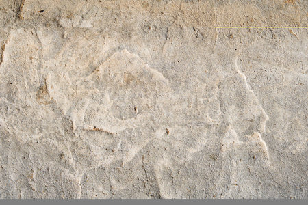 Cracked concrete wall covered with gray cement surface. Gray old wall with shabby damaged plaster or cement and brick background of an vintage dirty plaster. Mock up.の写真素材