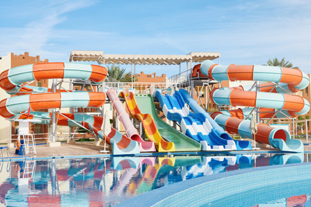 Water park with water colored flights, slides, splashes and pools. summer vacation activity on holiday at outdoor waterpark or aquapark. Concept summer travel and vacation background.の写真素材