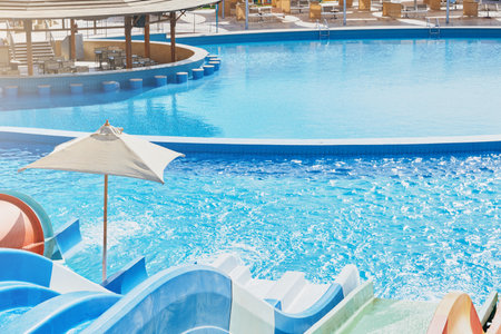 Water park with water colored flights, slides, splashes and pools at luxury hotel. summer vacation activity on holiday at outdoor waterpark or aquapark. Concept summer travel and vacation background.の写真素材