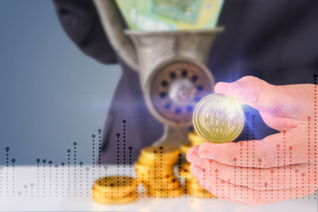 Businessman man holding bitcoin coin against stacks of gold coins and paper money coming out of old meat grinder and virtual holographic graph. Earning money, exchange, profitable, investment conceptの写真素材
