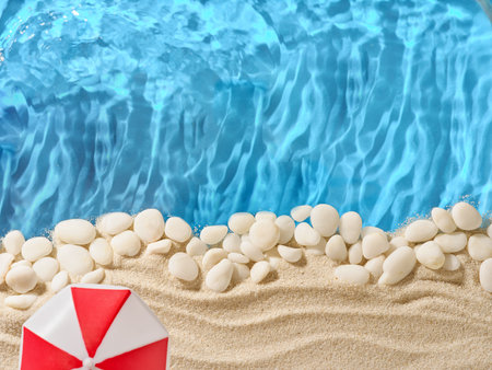 Summer background with sand, white stones, red sun umbrella on edges and blue background sea water with wave. Tourism, vacation and holidays concept. Design Element. Holidays vacation background.の写真素材
