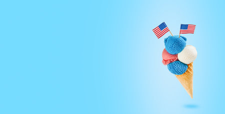 4th of July Holiday background. Colorful ice cream cone with red, white and blue scoops patriotic colors flavors flying in air on blue background. Happy Independence Day concept. Mock up.の写真素材