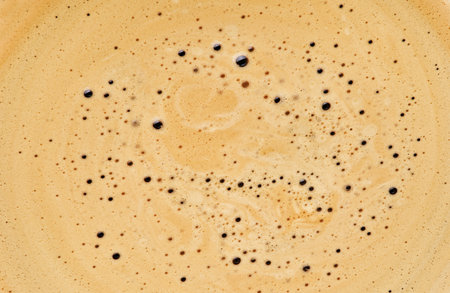 Coffee drink background. Cappuccino creamy milk foam texture. Top view on white background. Design element.の写真素材