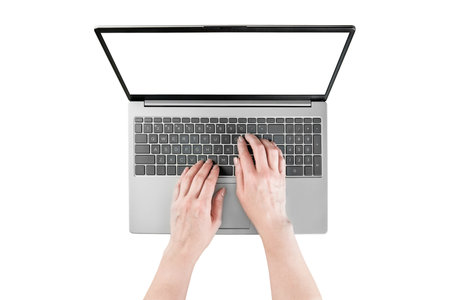 Female hands typing text or working on laptop with empty screen isolated on white background with clipping path. Top view. Design elementの写真素材
