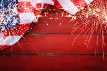 4th of July American Independence Day. American flag and freworks on red old rustic wooden background with copy space.Memorial Day, Happy Martin Luther King day, Labor day. Copy space. Mock up.の写真素材