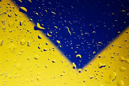 Water drops on clear glass with yellow/blue backgroundの写真素材