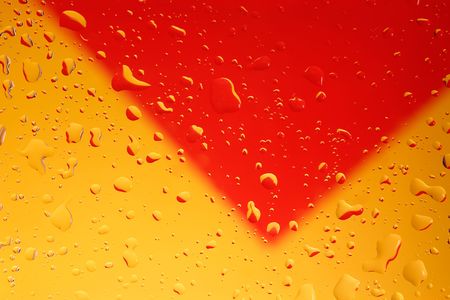 Water drops on clear glass with yellow/red backgroundの写真素材