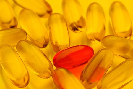 macro of pills with red pill standing outの写真素材