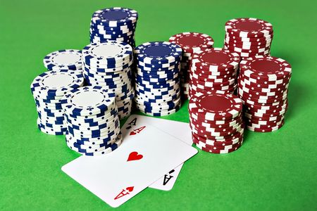 Pocket Aces and poker chips on a game table
