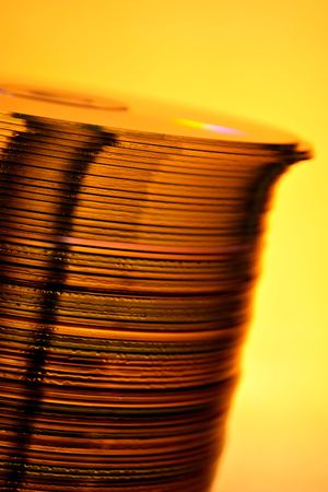 Stack of Cds on yellow background