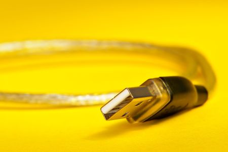 USB cable on yellow backgroundの写真素材