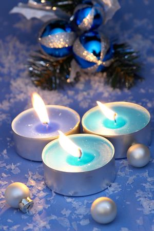 Burning candles, ornaments, blue settingの写真素材